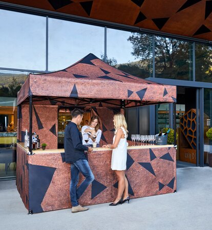 Personalised folding gazebo 3x3m with sublimation photo print, sidewalls and wooden counter for cocktail bars in the gastronomy and catering sector.