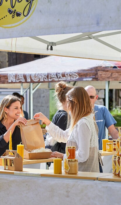 3x3 m square market gazebo with flat roof and half-height walls with counter for selling honey. Fully customised gazebo with honey and bee themed sublimation printed photos and logo. 