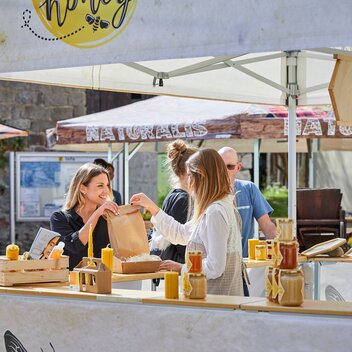 3x3 m square market gazebo with flat roof and half-height walls with counter for selling honey. Fully customised gazebo with honey and bee themed sublimation printed photos and logo. 