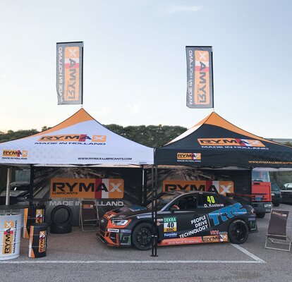 Gazebo Motorsport 3x3 m nero e bianco in sistema modulare. Grafica completamente personalizzata Rymax con pareti laterali e bandiere. Gazebo utilizzato come scuderia auto da corsa. 