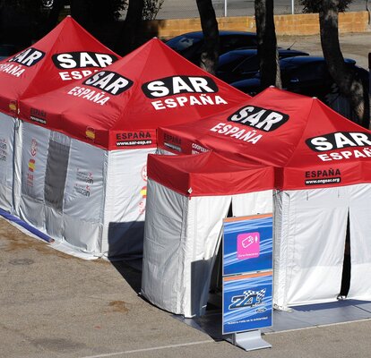 The four rescue tents of different sizes are connected to each other. They have white side walls and red tent roofs.