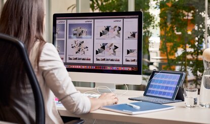 A graphic employee is sitting in front of the computer. She is designing a gazebo for a customer. 