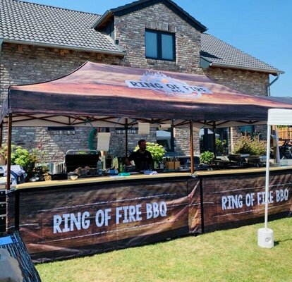 Custom printed 8x4 m gazebo with brown frame and half-height side wall with street food counter with "Ring of Fire BBQ" logo