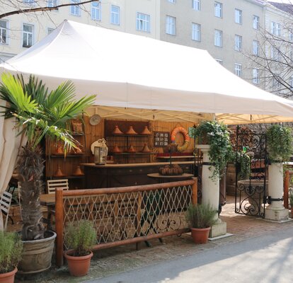 Elegant 8x4m beige gazebo with decorative curtains and beige frame for bar hotel restaurant