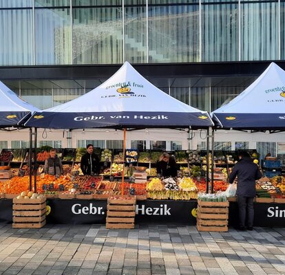 For the fruit market, three gazebos from Gebr. van Hezik with full-surface printing, awnings and black structure are located at the fruit market.
