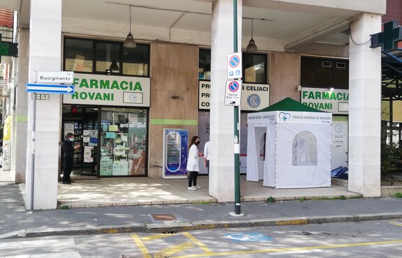 A white Covid-19 testing tent stands in front of the Farmacia Rovani 
