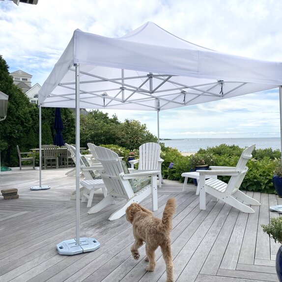 White folding gazebo 6x4 m for seaside terrace