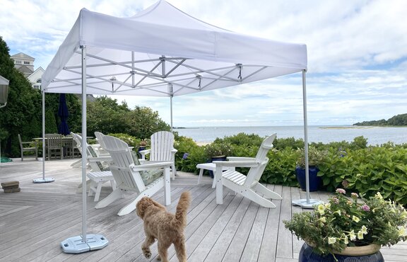 White folding gazebo 6x4 m for seaside terrace