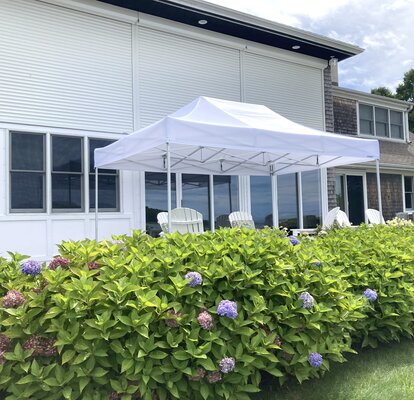 Folding gazebo with white frame for terrace. Outdoor gazebo protects from sun and rain with an elegant touch. 