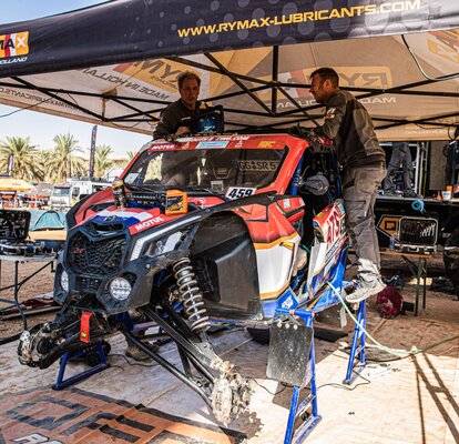 The race tent is located at the Dakar Rally 2022 and protects Rymax car and  mechanics from the sun