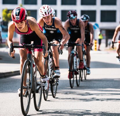 The picture shows five cyclists taking part in a triathlon.