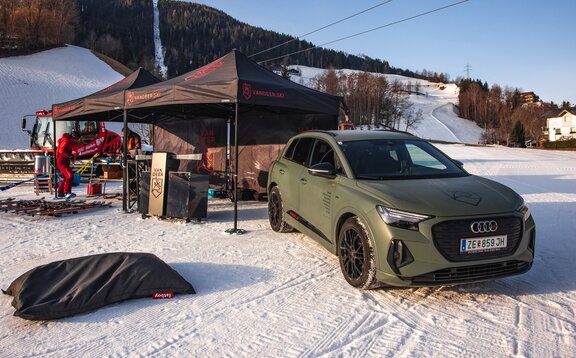 Van Deer Red Bull Ski Sports Promotion Event auf eingeschneiter Skipiste mit Pistenraupe unter Seilbahn mit 2 3x3 m Mastertent Faltpavillons für Service und Ausrüstung und Audi Werbefahrzeug | © Sebastian Hoellwart