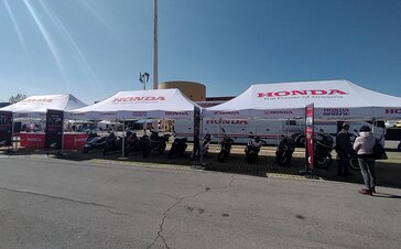 3 Mastertent folding pavilion 8x4 branded by Honda Italy on parking lot as exhibition space for motorcycles with advertising display
