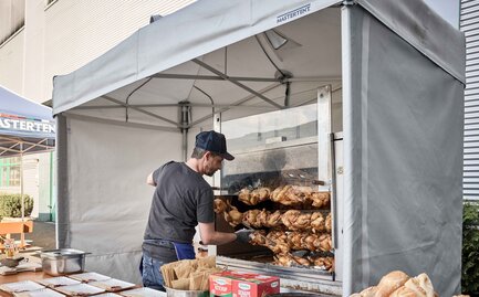 Cook cooks the spit at an event under a Mastertent fireproof and refractory kitchen gazebo
