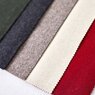 The five fabrics of the loden tent are lying next to each other: green, dark grey, light grey, beige, red. 