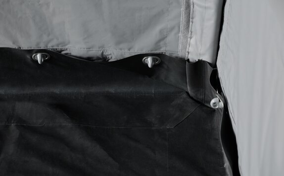 In the kit Rescue the sidewalls are connected to the floor. The woman is putting the pole through the loops. 