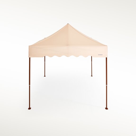 Ecru gazebo with brown structure and scalloped valance. 