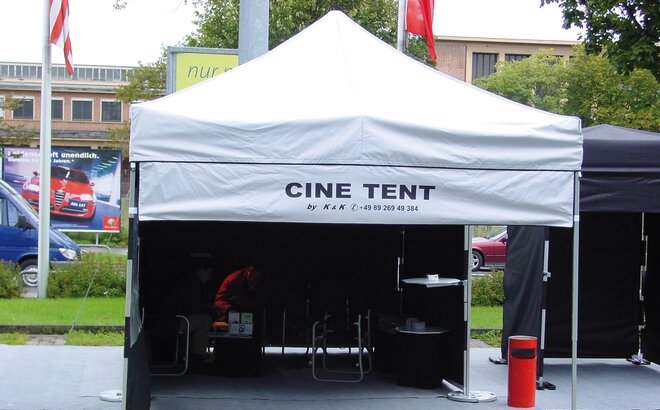 The custom made gazebo is equipped with a removable banner on which the incription "CINE TENT" is printed. The banner is attached with velcro strips at the roof and gazebo legs. 