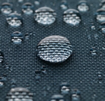 Blue gazebo fabric with large drops of water.