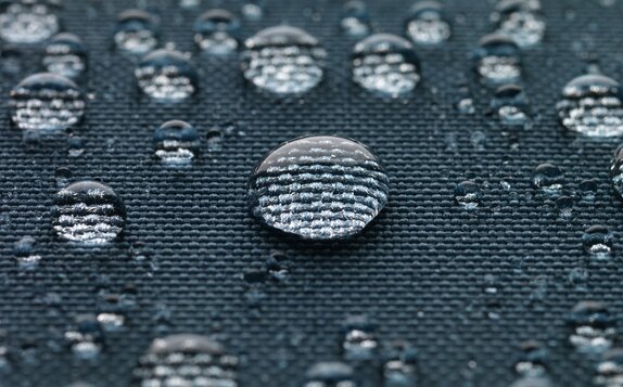 Blue gazebo fabric with large drops of water.