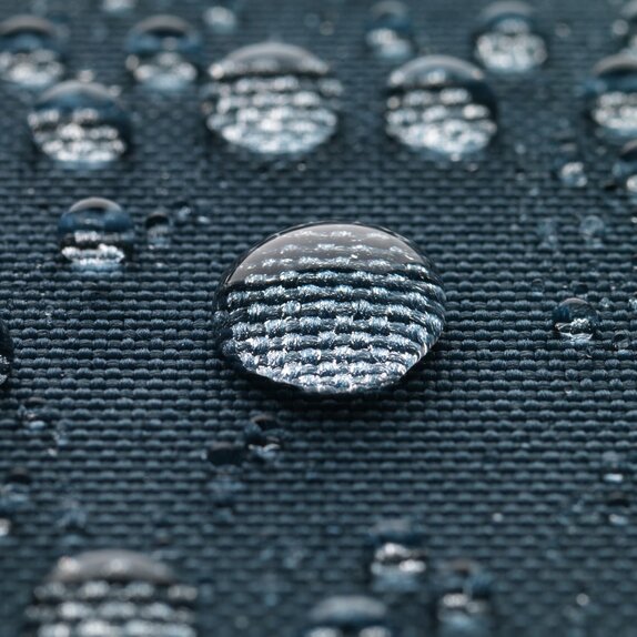 Blue gazebo fabric with large drops of water.