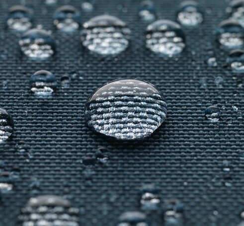 Blue gazebo fabric with large drops of water.