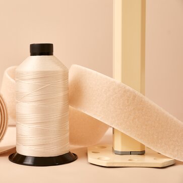 Ecru fabric, ecru velcro stip, ecru fabric roll and ecru structure for gazebos located side by side. 