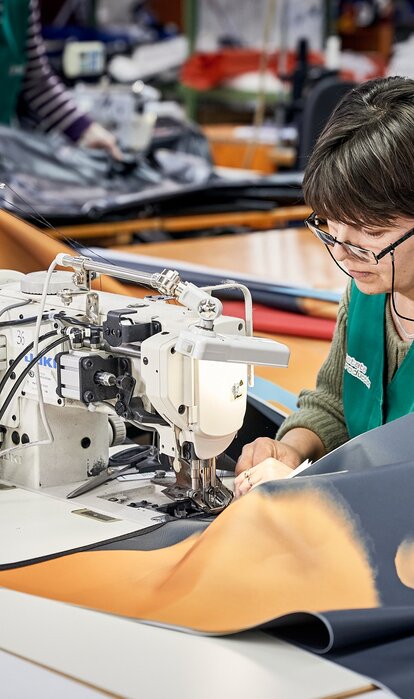 The folding pavilions are sewn together in the sewing room.