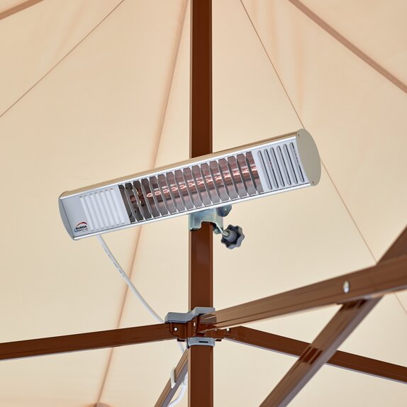 A mobile infrared heater mounted on the mast of a Mastertent canopy tent.