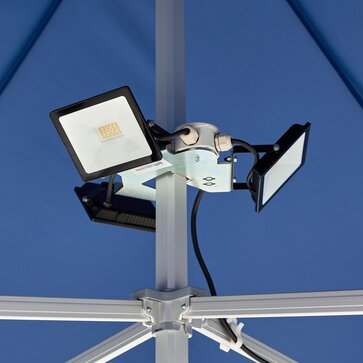 Three LED spotlights are mounted on the blue folding pavilion. The LED spotlights are all off.