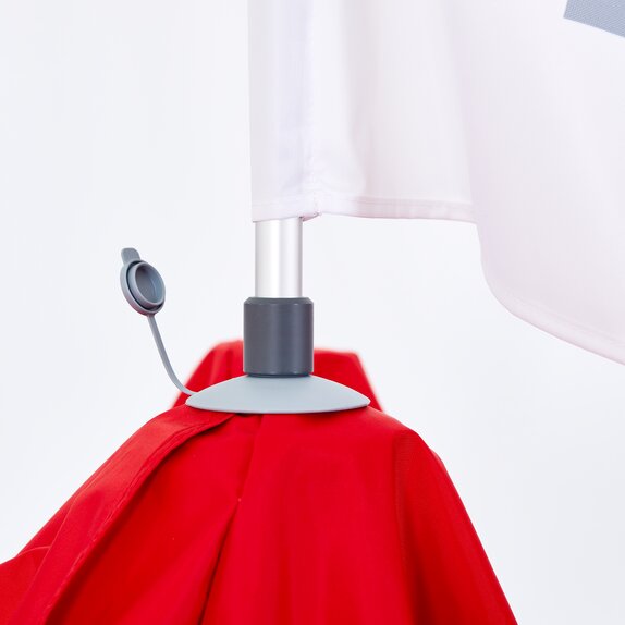 A close up view of the peak cap of a red Mastertent canopy tent.