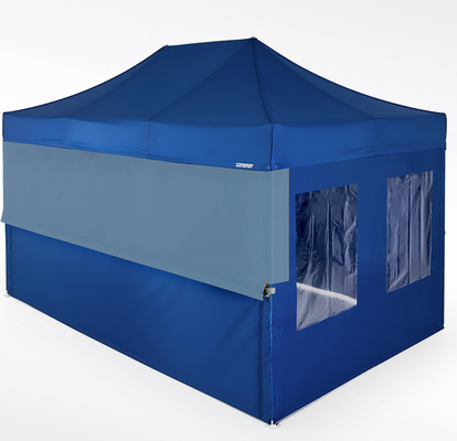 A Mastertent with blue roof and sidewalls with a yellow upper closure wall to fully enclose a half-height wall.